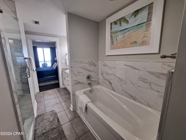 bathroom featuring a tub, tile patterned flooring, and vanity