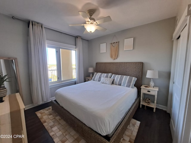 bedroom featuring a closet, dark hardwood / wood-style floors, and ceiling fan