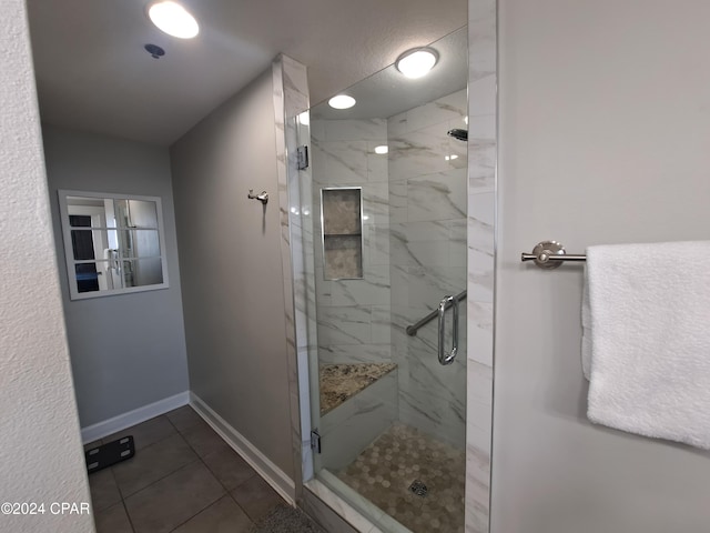 bathroom with tile patterned floors and walk in shower