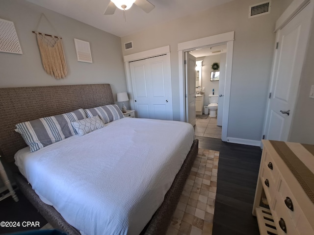 bedroom featuring ceiling fan, a closet, ensuite bathroom, and dark hardwood / wood-style floors