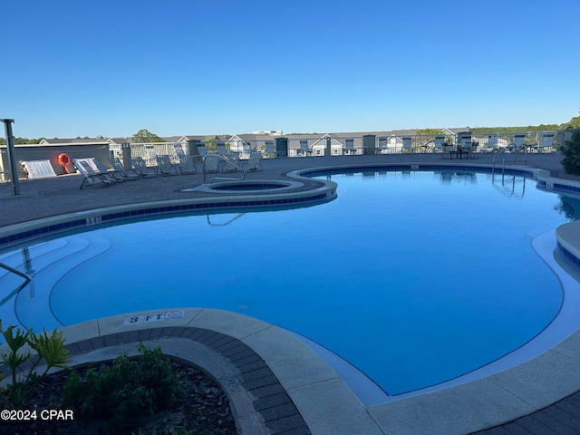 view of swimming pool featuring a community hot tub