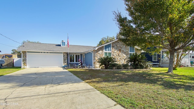 view of front of property with a front yard and a garage