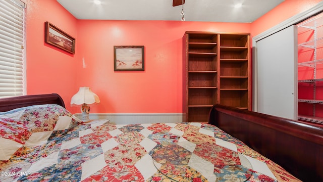 bedroom with ceiling fan and a closet