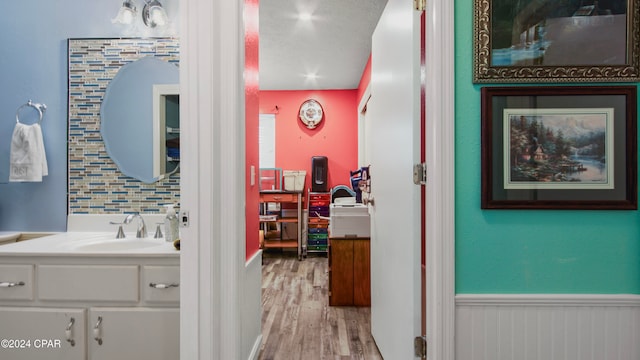 bathroom featuring vanity, hardwood / wood-style floors, and a textured ceiling