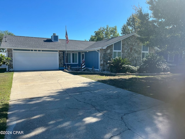 ranch-style home featuring a garage and central AC unit