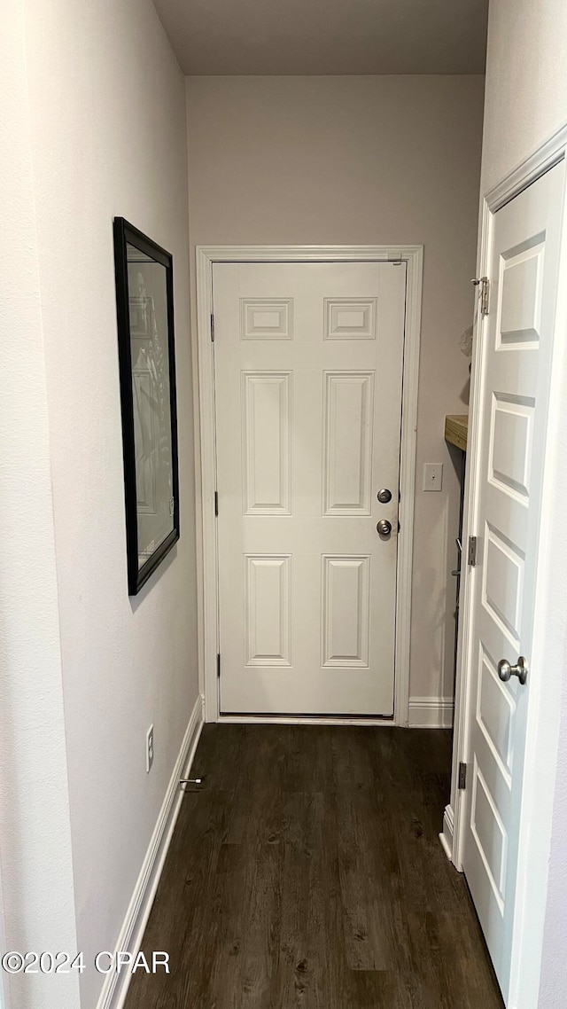 doorway with dark hardwood / wood-style floors