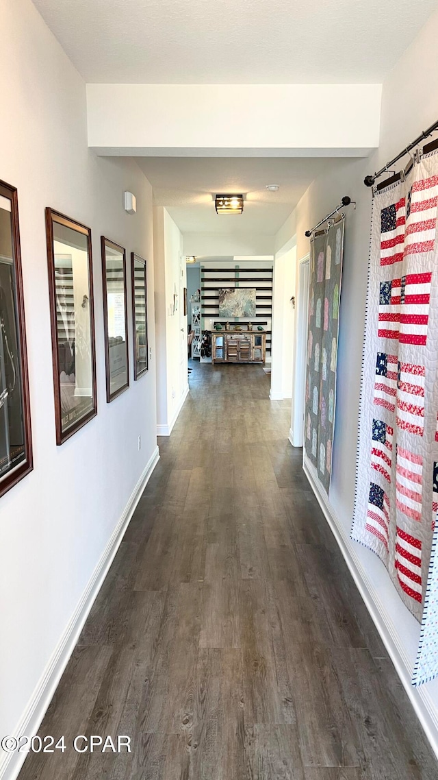 hallway with dark hardwood / wood-style floors