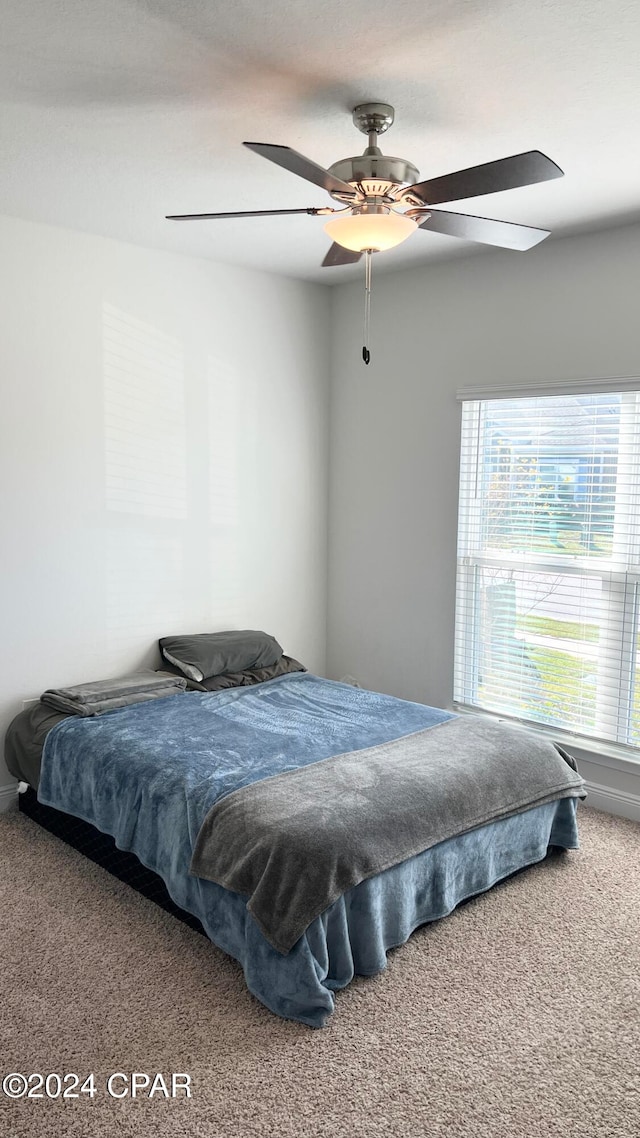 carpeted bedroom featuring ceiling fan