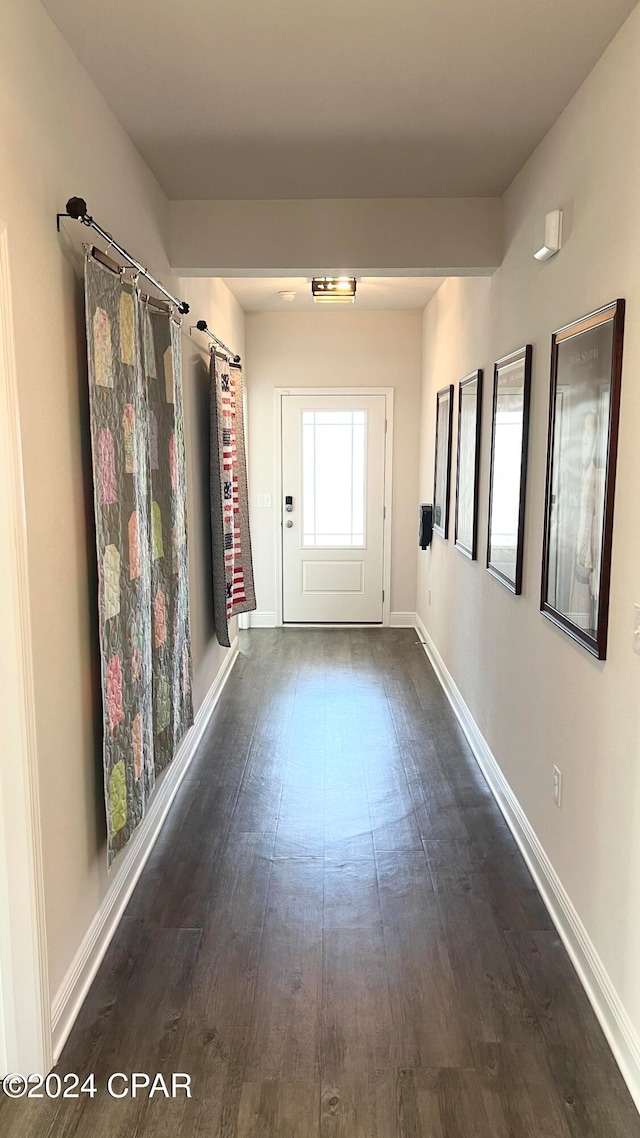 hall with dark hardwood / wood-style flooring