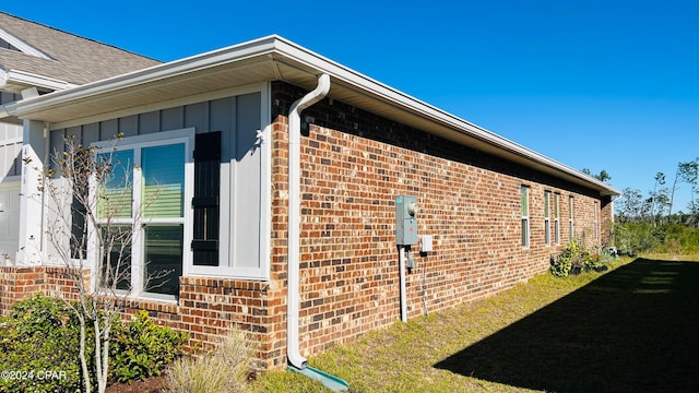 view of side of home featuring a lawn