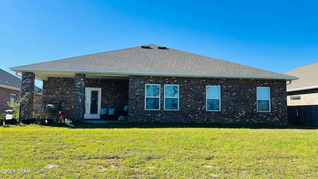 back of house with a lawn