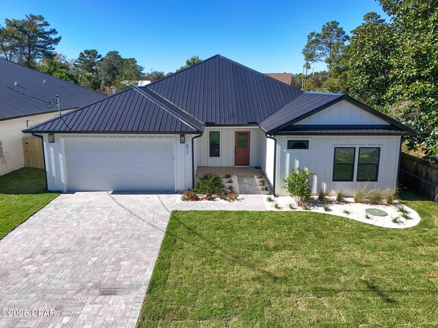 modern farmhouse with a garage and a front yard