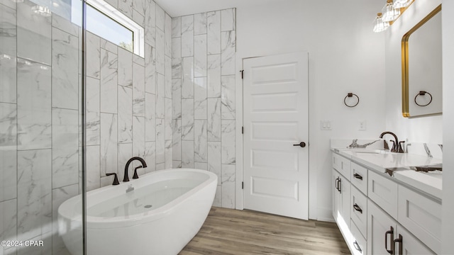 bathroom featuring hardwood / wood-style floors, vanity, and a bathtub