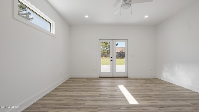 unfurnished room featuring ceiling fan, light hardwood / wood-style floors, and french doors