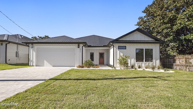 view of front of house with a garage and a front lawn