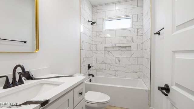 full bathroom with vanity, toilet, and tiled shower / bath