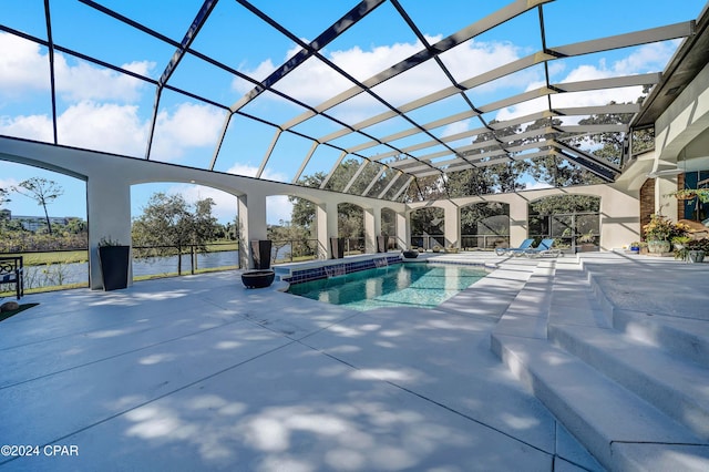 view of swimming pool featuring a lanai, a patio, and a water view