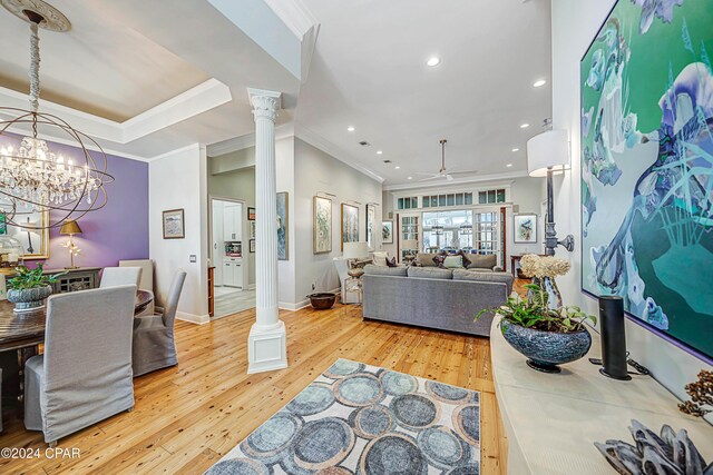 living room with ceiling fan, crown molding, light hardwood / wood-style flooring, and ornate columns