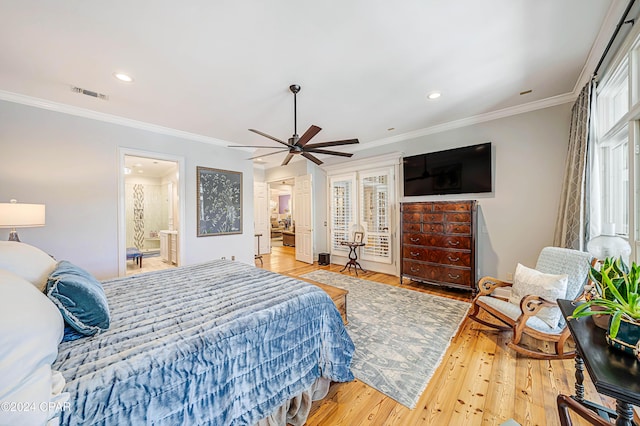 bedroom featuring light wood-type flooring, ceiling fan, multiple windows, and ensuite bath