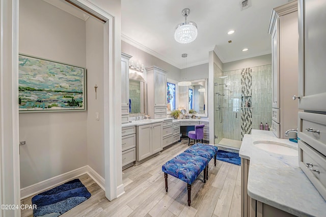 bathroom featuring crown molding, vanity, a shower with shower door, and wood-type flooring