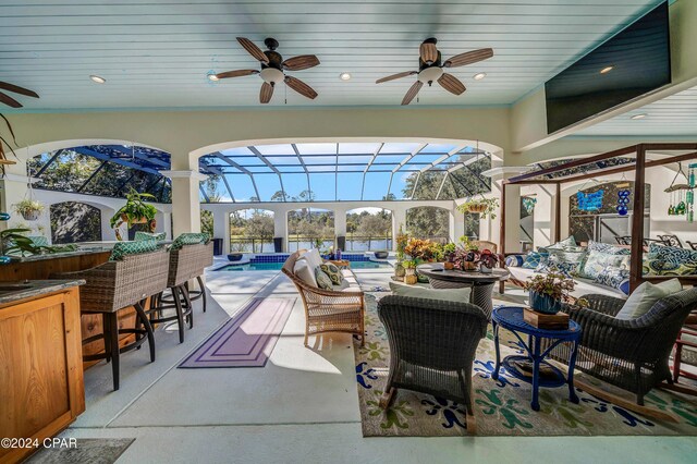 sunroom with ceiling fan, wood ceiling, and a pool