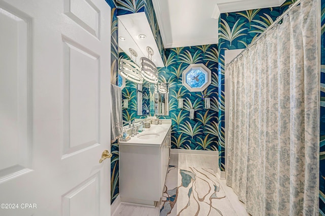 bathroom with vanity and ornamental molding