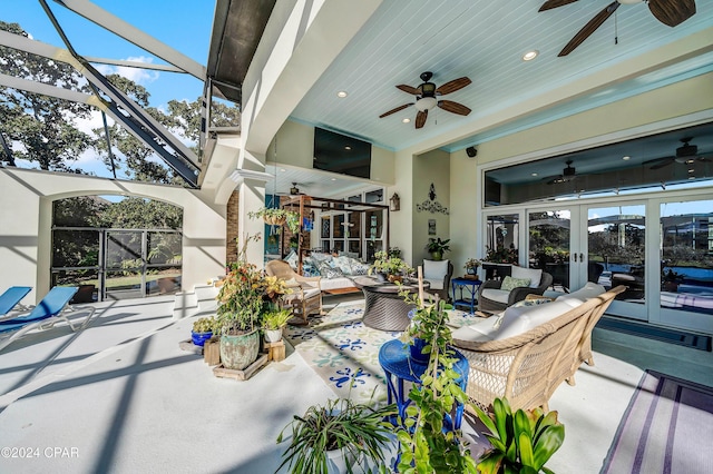 view of patio / terrace with a lanai, an outdoor living space, french doors, and ceiling fan