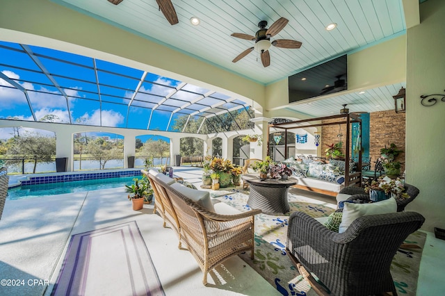 sunroom with ceiling fan, plenty of natural light, and wooden ceiling