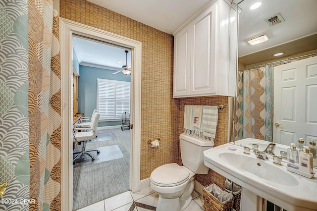 bathroom with sink, toilet, crown molding, and tile patterned flooring