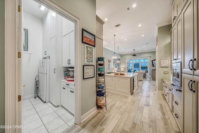 hallway featuring light wood-type flooring and crown molding