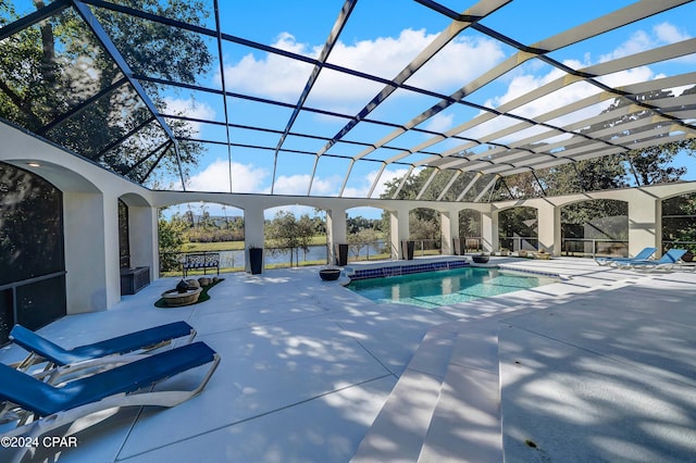 view of swimming pool featuring a lanai, a water view, and a patio