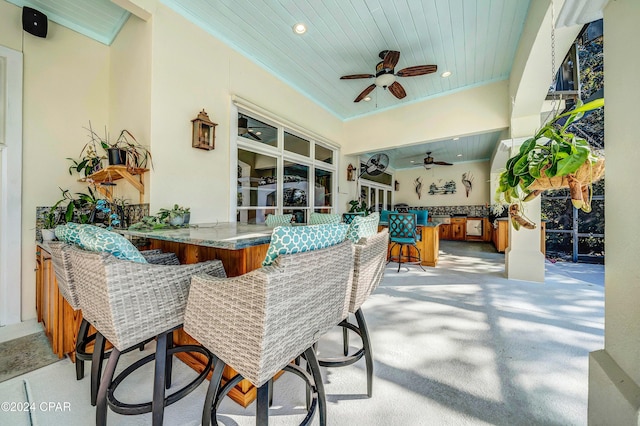 view of patio / terrace with ceiling fan and an outdoor bar