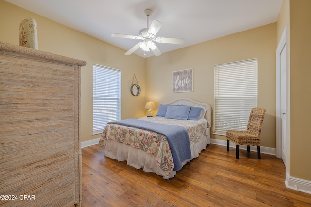 bedroom with hardwood / wood-style floors, a closet, and ceiling fan