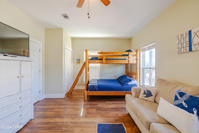 bedroom featuring ceiling fan, a closet, and hardwood / wood-style flooring