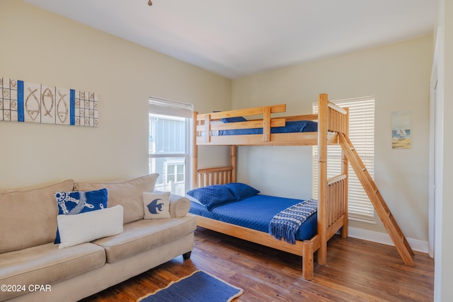 bedroom with dark hardwood / wood-style floors