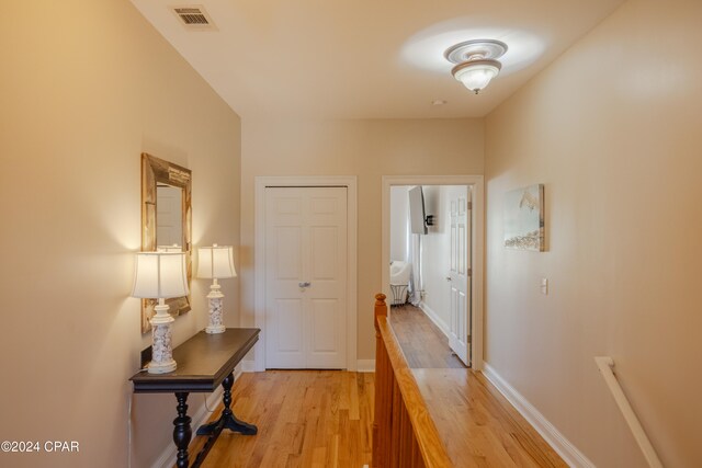 hall with light hardwood / wood-style floors