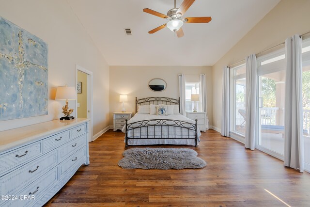 bedroom featuring access to exterior, lofted ceiling, ceiling fan, and dark wood-type flooring