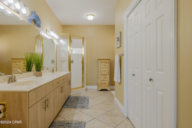 bathroom featuring vanity, tile patterned floors, and a shower with shower door