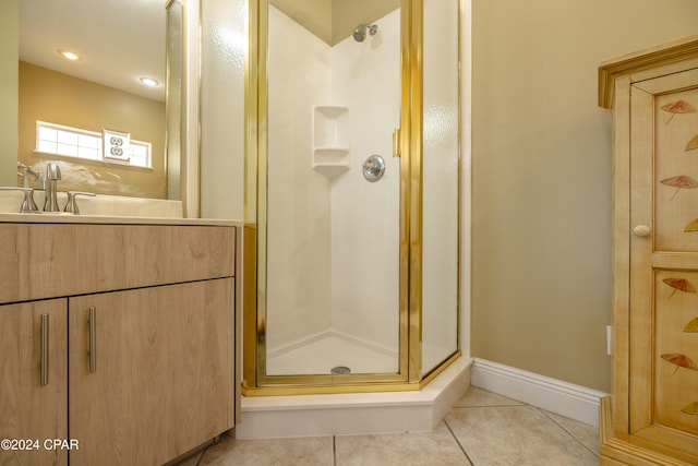 bathroom featuring tile patterned floors, a shower with door, and sink