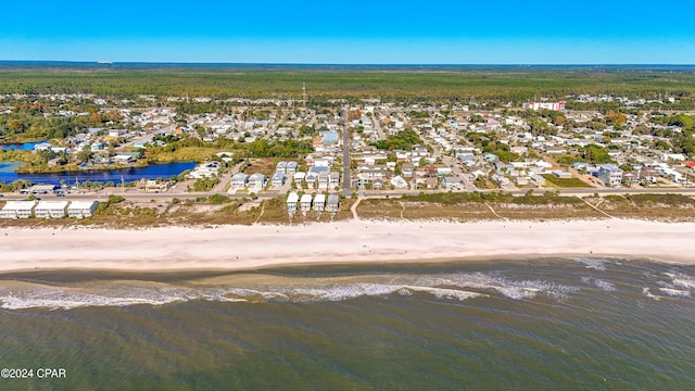 birds eye view of property with a water view and a beach view