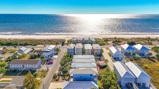 drone / aerial view with a beach view and a water view