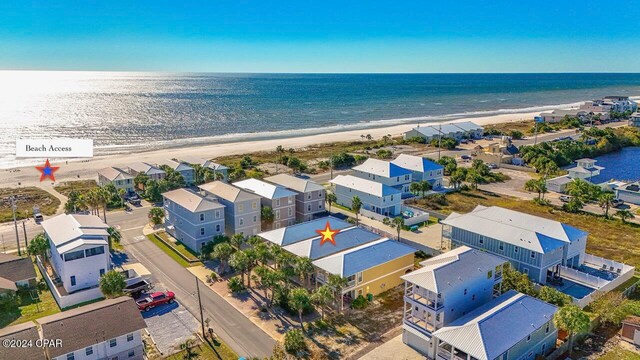 drone / aerial view featuring a water view and a view of the beach