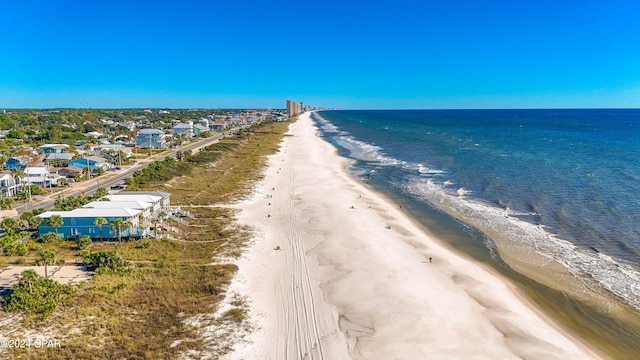 birds eye view of property featuring a water view and a view of the beach