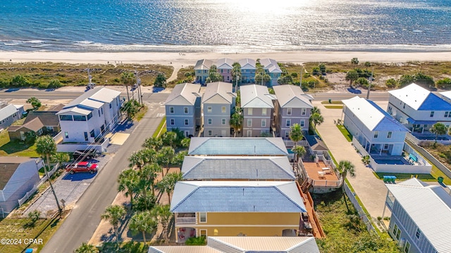 birds eye view of property with a water view and a view of the beach