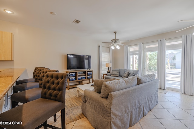 living room with ceiling fan and light tile patterned flooring