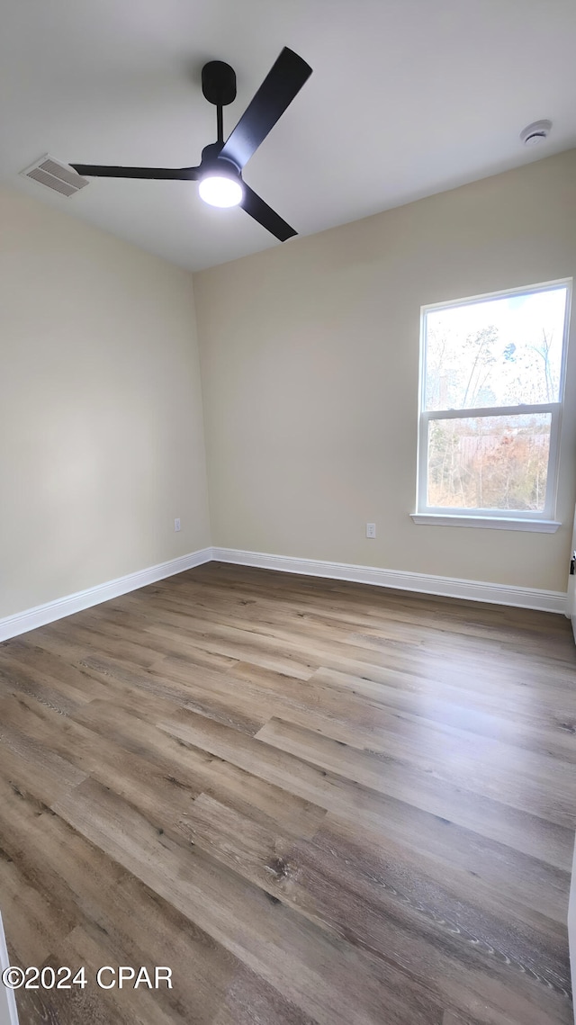 spare room with wood-type flooring and ceiling fan