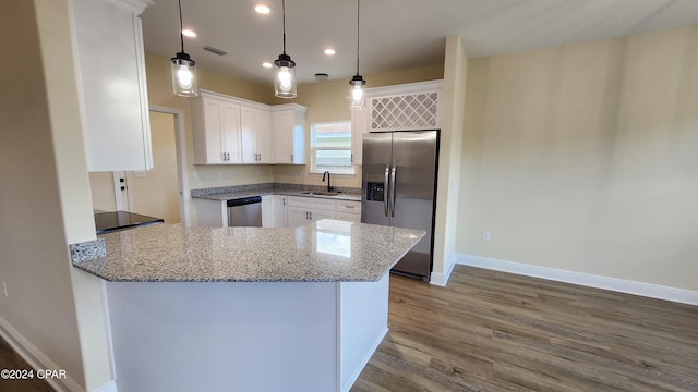 kitchen featuring white cabinetry, sink, stainless steel appliances, and wood-type flooring