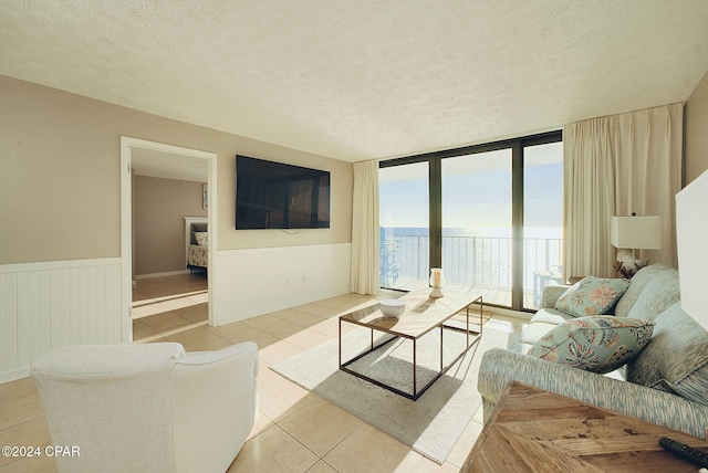 living room with light tile patterned floors and a textured ceiling