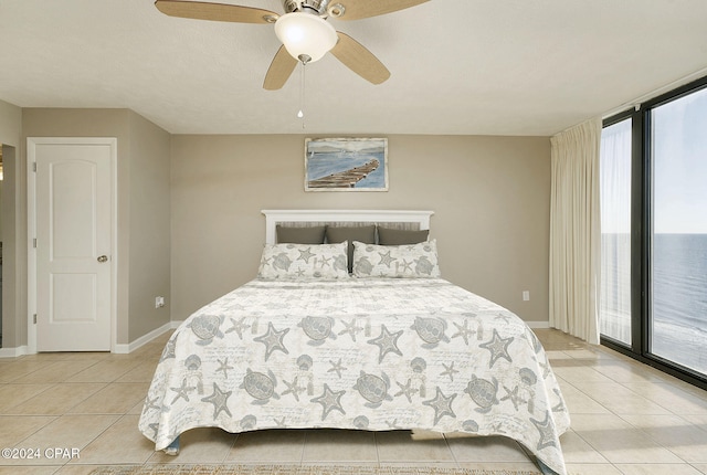 tiled bedroom featuring ceiling fan and access to outside