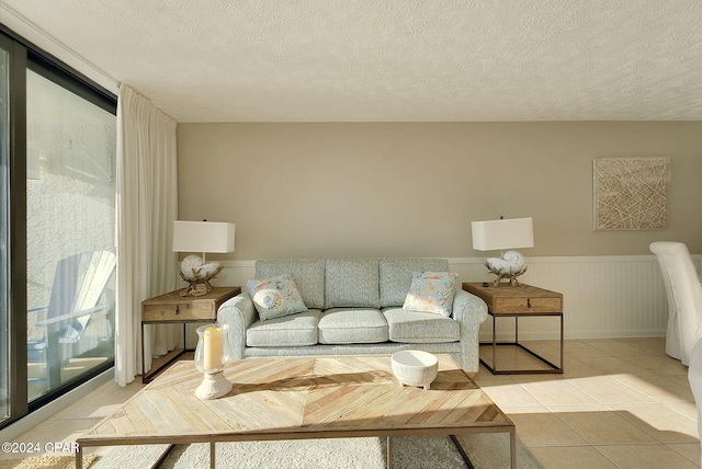 tiled living room featuring a textured ceiling